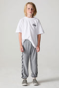 Full body front view of a boy wearing the Chaser Color Block Heather Grey Barrel Leg Pants on a neutral background