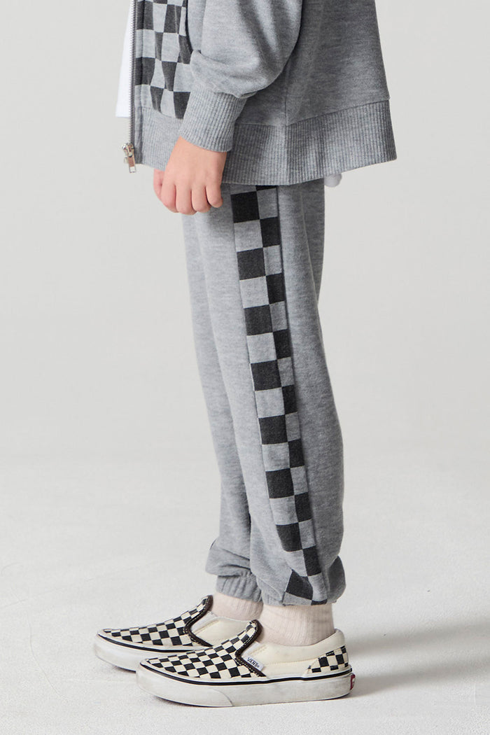 Side view of a boy wearing the Chaser Color Block Heather Grey Barrel Leg Pants on a neutral background