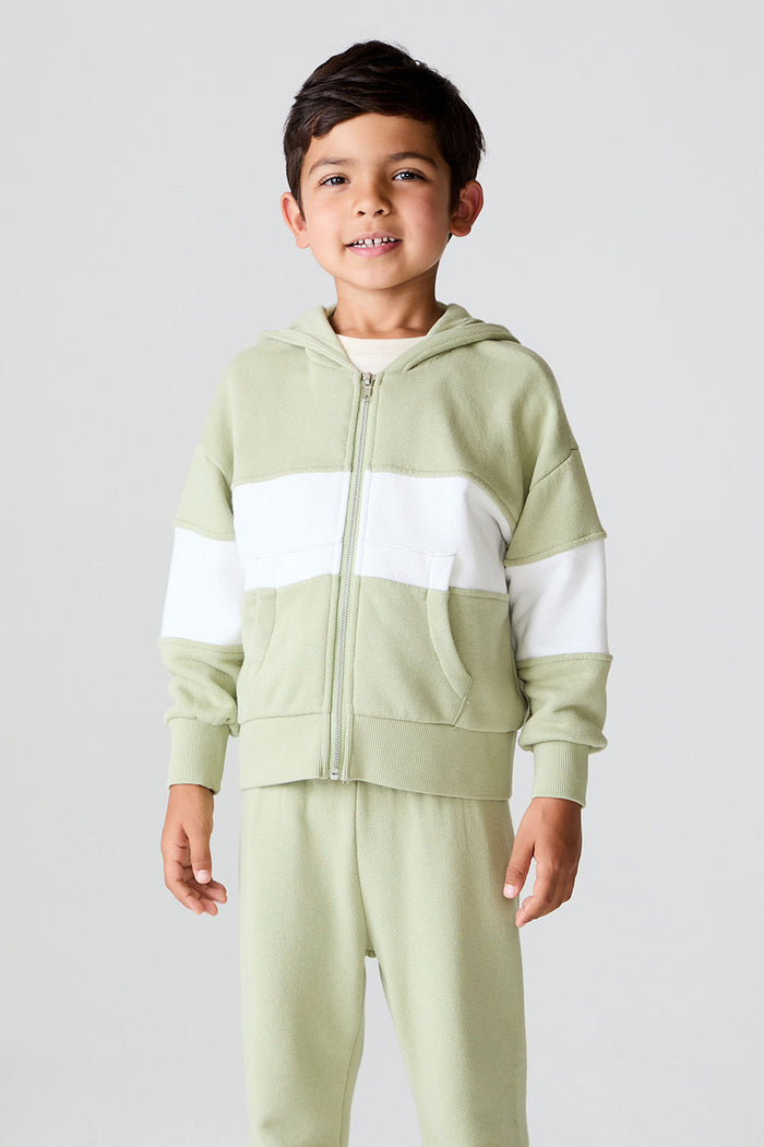 Front view of a boy wearing the Chaser Color Block Paxton Zip Up Hoodie and matching pants on a neutral background
