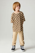Full body front view of a boy wearing the Chaser Color Blocked Jogger on a neutral background with shirt and matching checkered pants