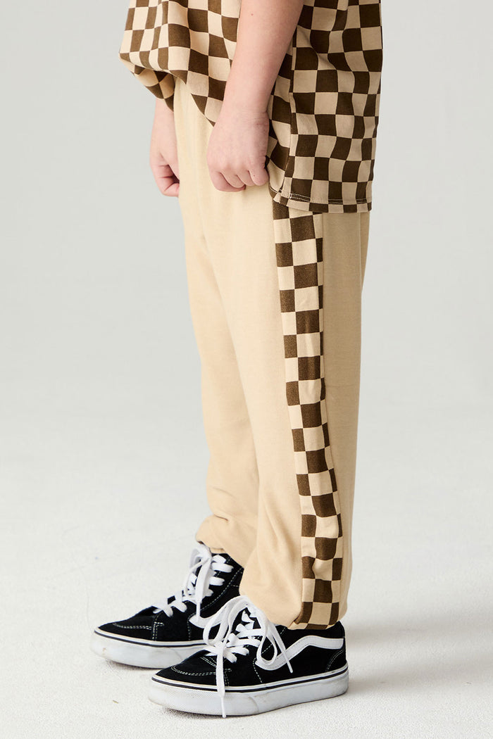 Side  view of a boy wearing the Chaser Color Blocked Jogger on a neutral background with shirt