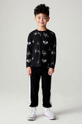 Side view of a boy wearing the Chaser Blocked Lounge Pants Boys Black Jogger on a neutral background with arms at sides and matching black  top