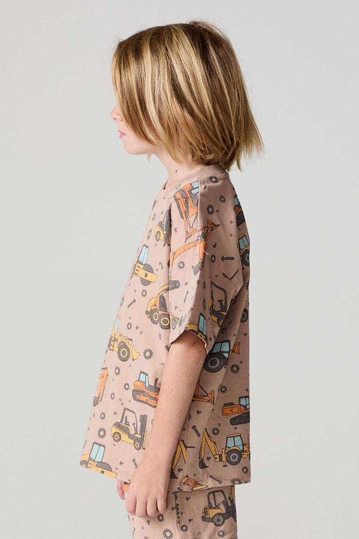 Side view of a boy wearing the Chaser Construction Days Tee on a neutral background