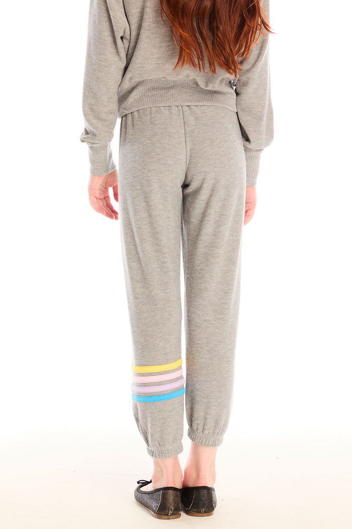 Back view of girl wearing Chaser’s Heather Grey Contrast Strappings Pants with colorful accents on the left leg on a white background