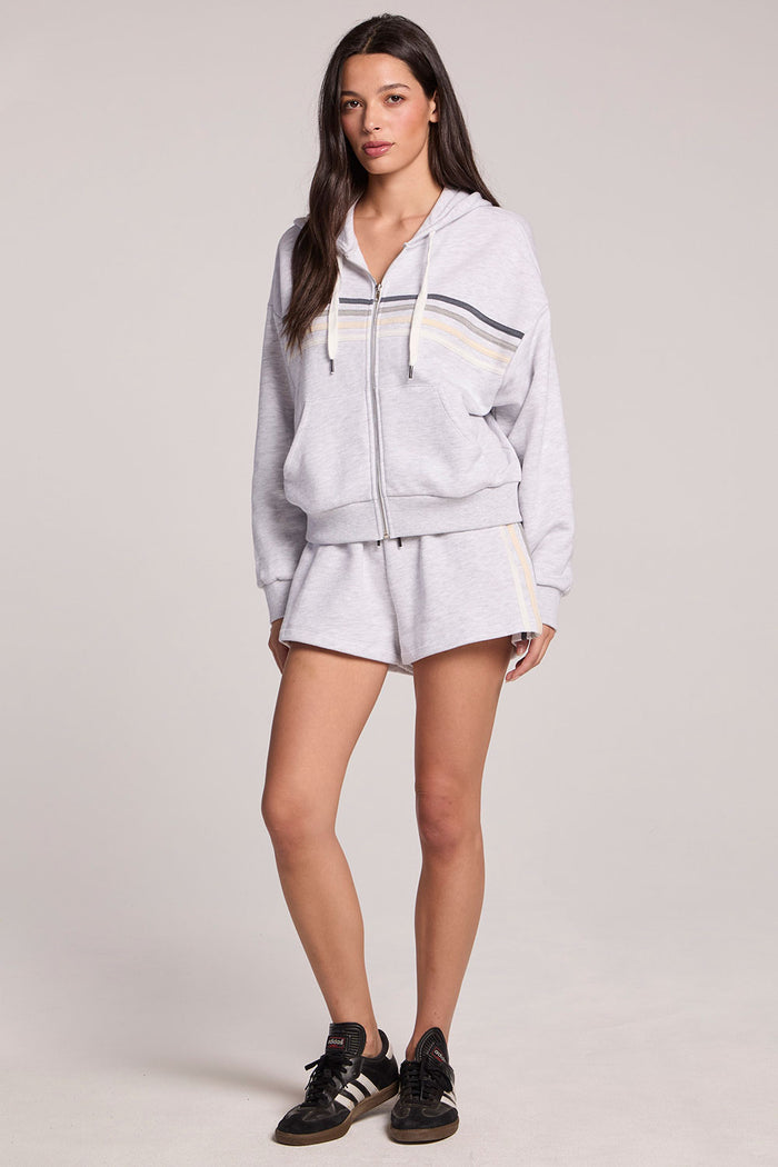 A full body front view of a woman wearing the Chaser Contrast Strappings Shorts on a neutral background