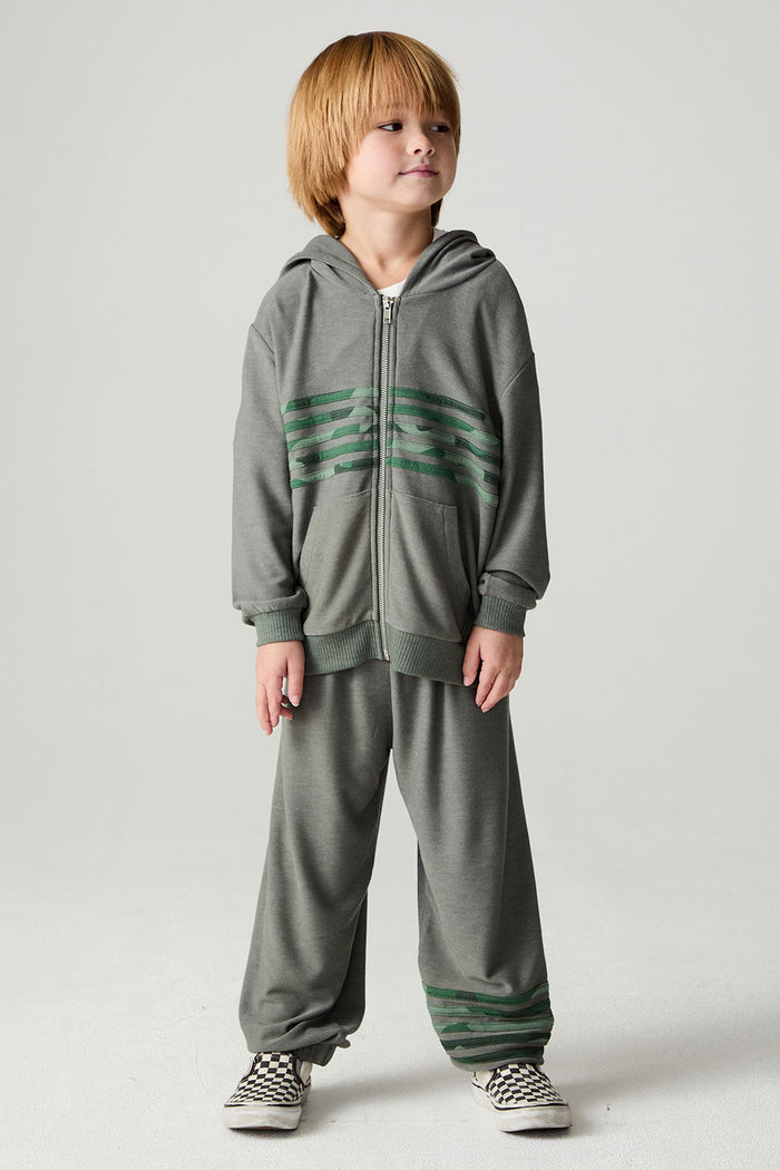 A full body front view of a boy wearing the Chaser Cool Camo Boys Zip Up on a neutral background