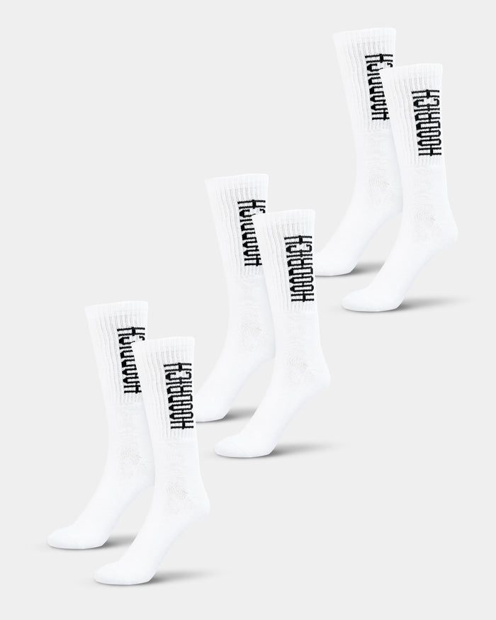 Three pairs of white crew socks with black text branding on the side, displayed in a stacked arrangement.