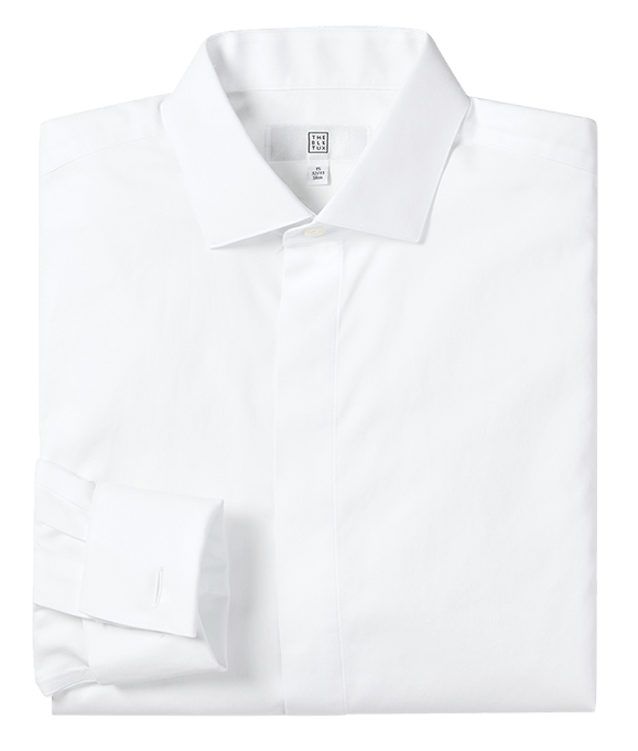 White fly-front tuxedo shirt folded flat, showing spread collar and covered placket.