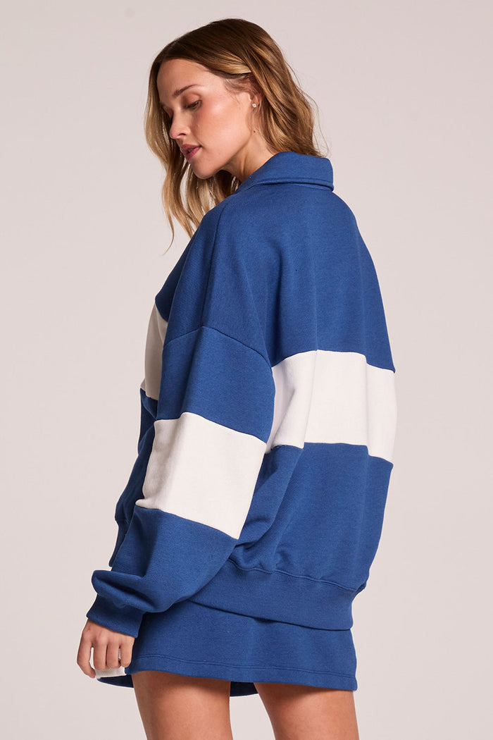 Back view of a woman wearing the Chaser Courtside Long Sleeve on a neutral background