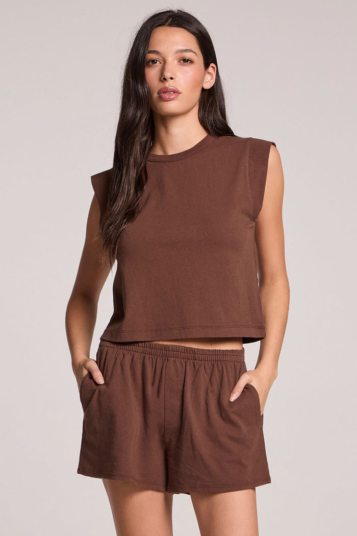 Front view of a woman wearing the Chaser  Cropped Cap Sleeve Kahlua Crewneck Tee and shorts on a neutral background