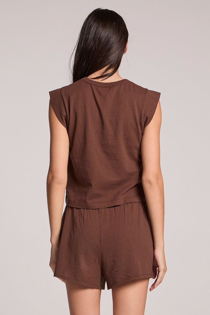 Back view of a woman wearing the Chaser  Cropped Cap Sleeve Kahlua Crewneck Tee on a neutral background