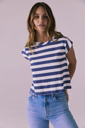 Model wearing the Chaser Cropped Castaway Stripe Cap Sleeve Crew Neck Tee featuring bold navy and white stripes and a relaxed cropped silhouette