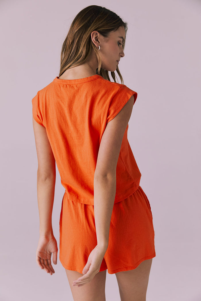 Back view of the Chaser Cropped Neon Flare Cap Sleeve Crew Neck Tee highlighting the clean hemline and smooth, lightweight fabric