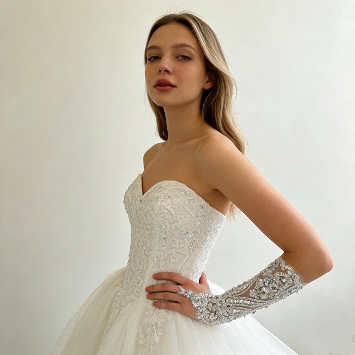 Handmade crystal embellished wedding gloves featuring pearl beads and sparkling embroidery for a luxury bridal look.