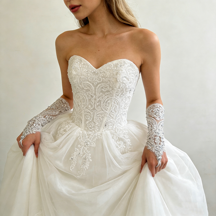 Handmade crystal embellished wedding gloves featuring pearl beads and sparkling embroidery for a luxury bridal look.