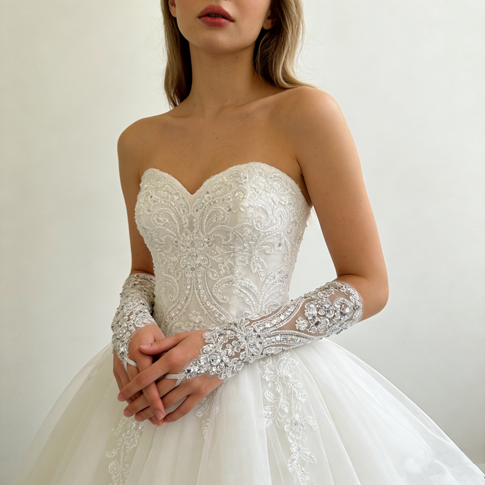 Handmade crystal embellished wedding gloves featuring pearl beads and sparkling embroidery for a luxury bridal look.