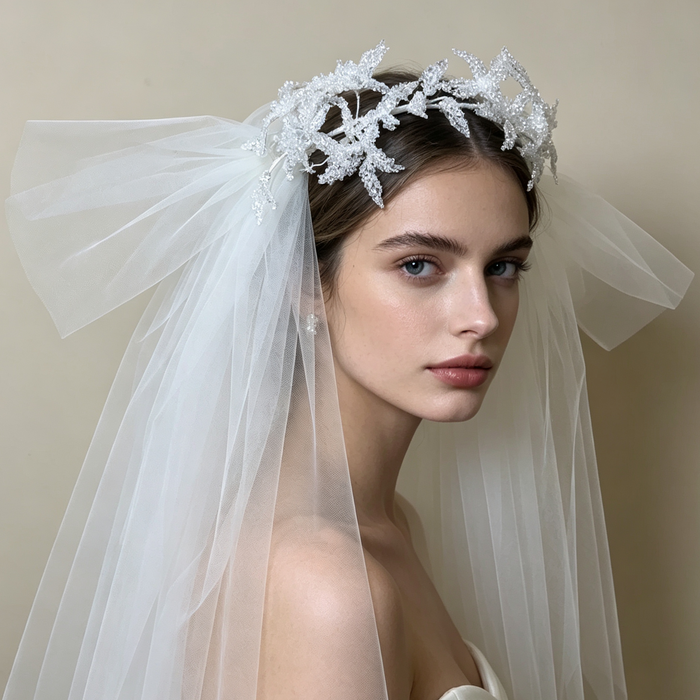 Bride wearing a sparkling flower crown veil headpiece with crystal details for a romantic wedding ceremony and bridal portrait.