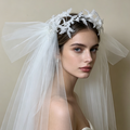Bride wearing a sparkling flower crown veil headpiece with crystal details for a romantic wedding ceremony and bridal portrait.