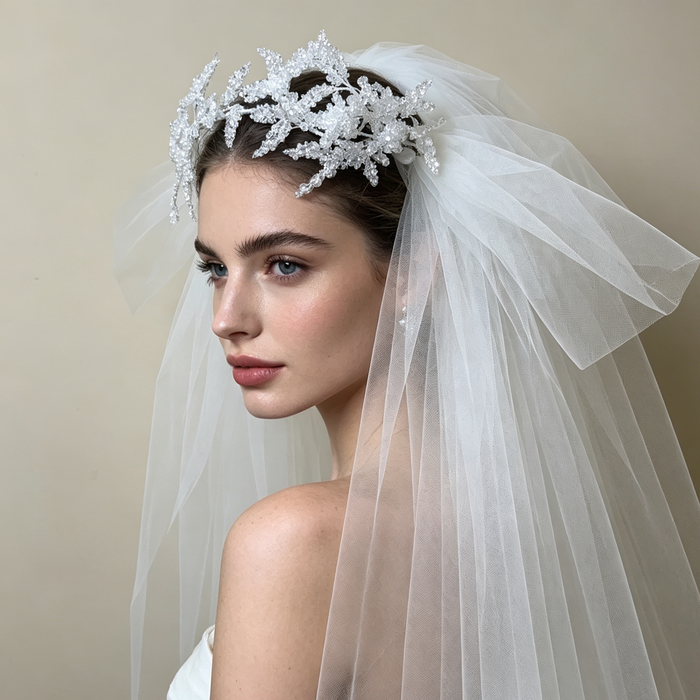 Bride wearing a sparkling flower crown veil headpiece with crystal details for a romantic wedding ceremony and bridal portrait.