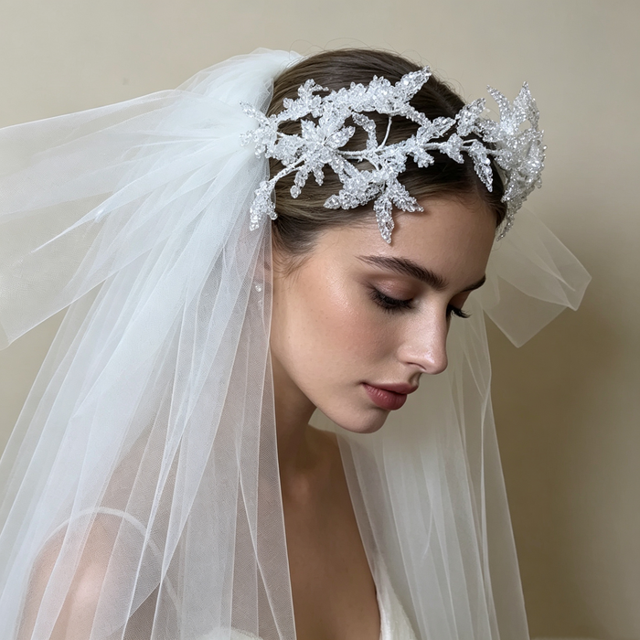 Bride wearing a sparkling flower crown veil headpiece with crystal details for a romantic wedding ceremony and bridal portrait.