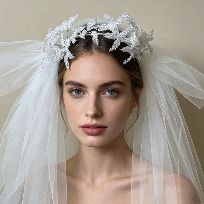 Bride wearing a sparkling flower crown veil headpiece with crystal details for a romantic wedding ceremony and bridal portrait.