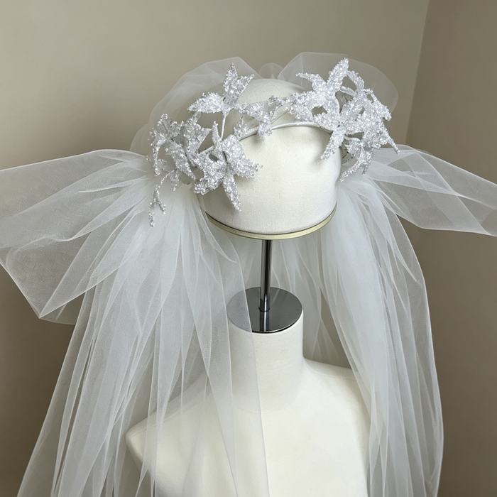 Handcrafted crystal floral bridal headband with long tulle veil for elegant wedding hair accessories and modern bride styling.