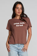 Front view of a woman wearing the Chaser Cute Buttired Top on a neutral background with blue jeans