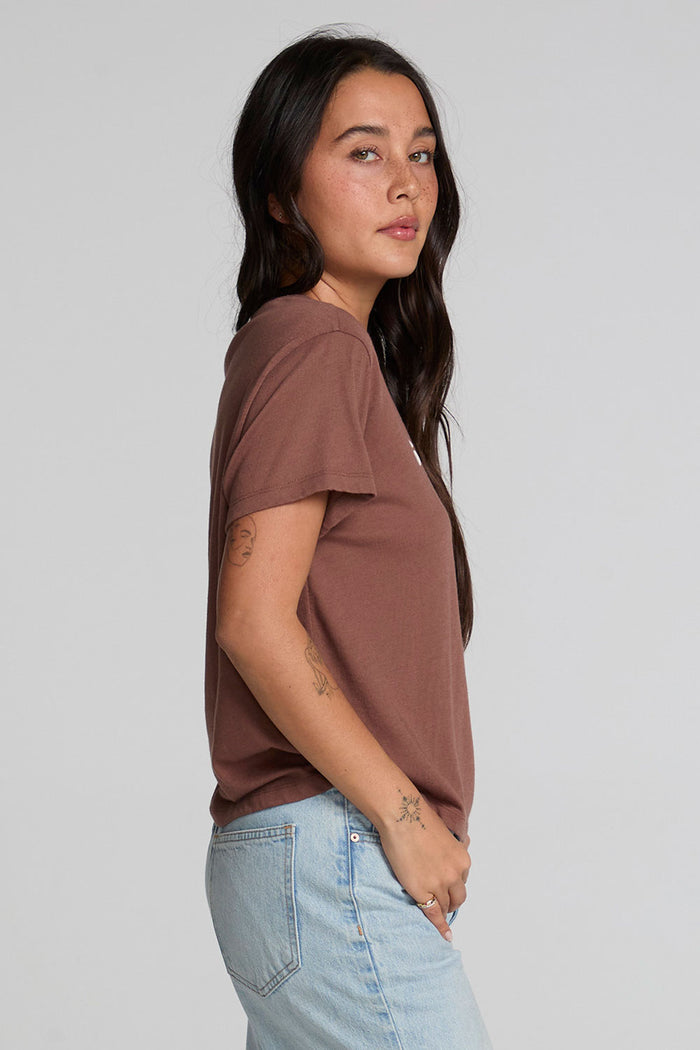 Back view of a woman wearing the Chaser Cute Buttired Top on a neutral background with jeans