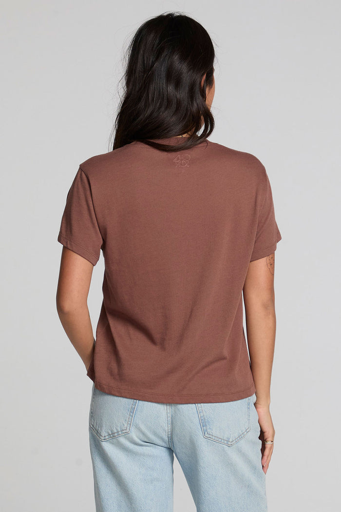 Back view of a woman wearing the Chaser Cute Buttired Top on a neutral background with pants