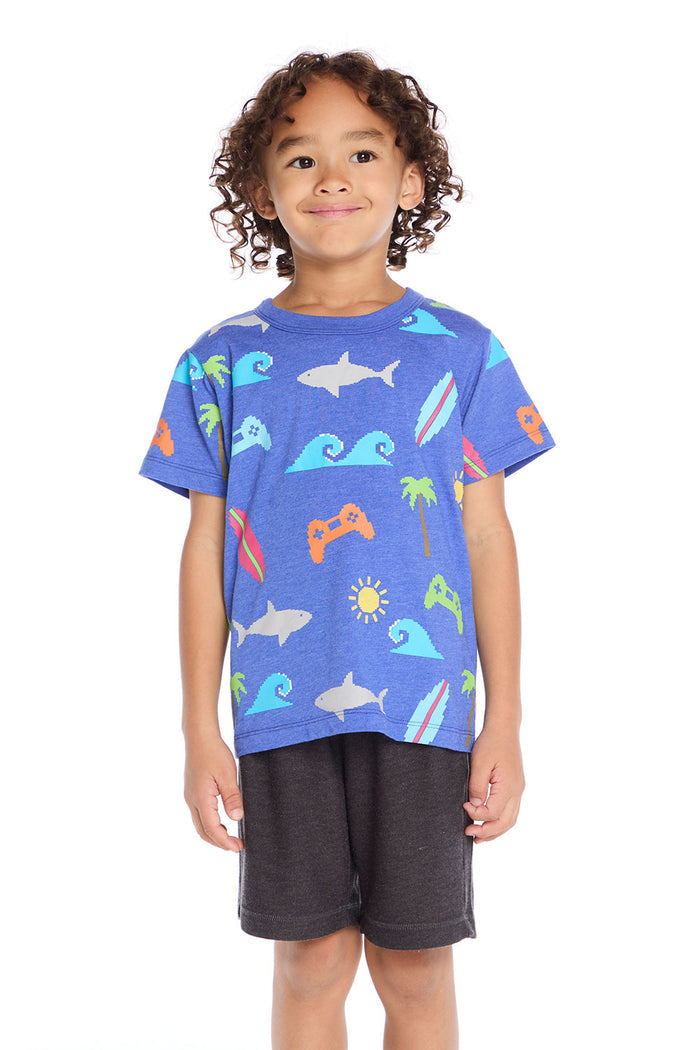 Boy wearing the Chaser Kids Cyber Surfer Tee in blue with colorful ocean and gaming graphics on a white background