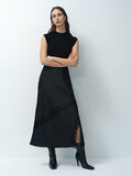 A woman wearing a dark grey midi-length skirt with lace detailing and a side slit and elastic waistband.