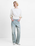 Woman wearing straight leg, high waisted jeans in a blue and beige denim wash