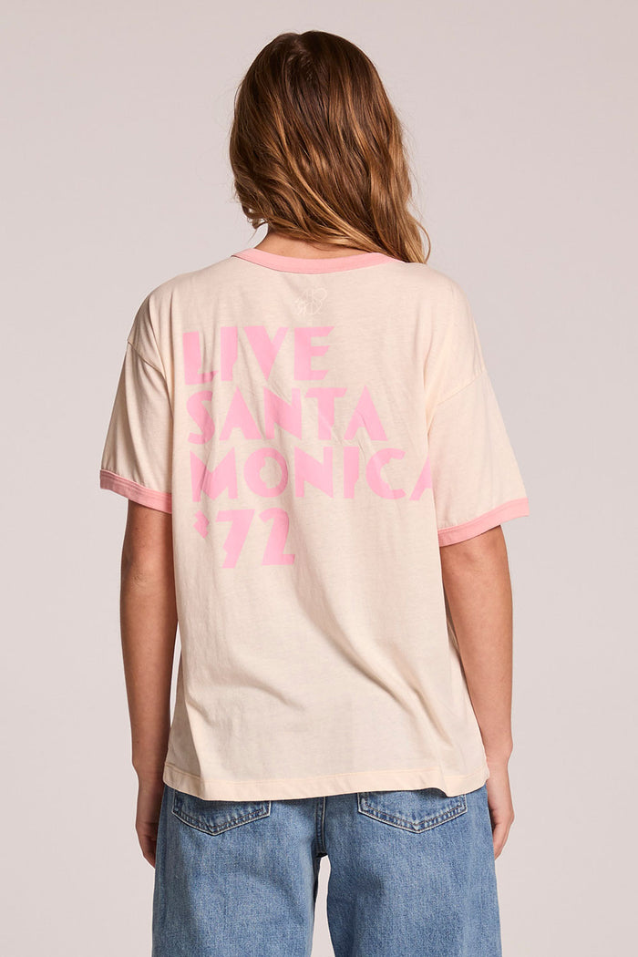 Back view of a woman wearing the Chaser  David Bowie Santa Monica '72 Tee on a neutral background