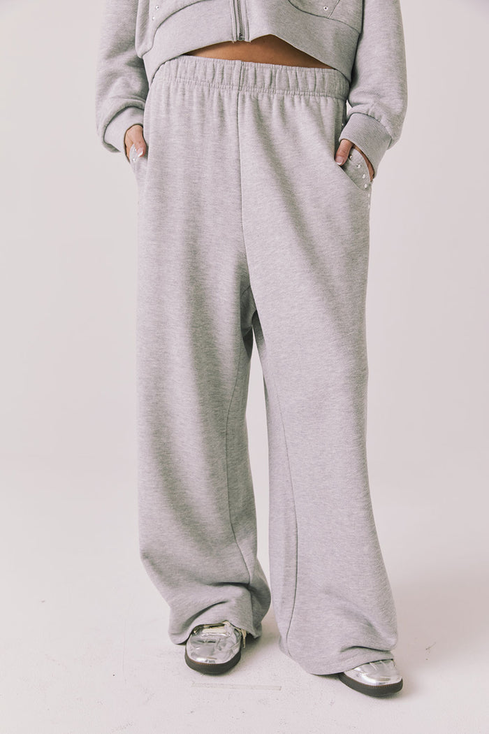 Front view of woman wearing Chaser’s Daze Heather Grey Joggers on a white background
