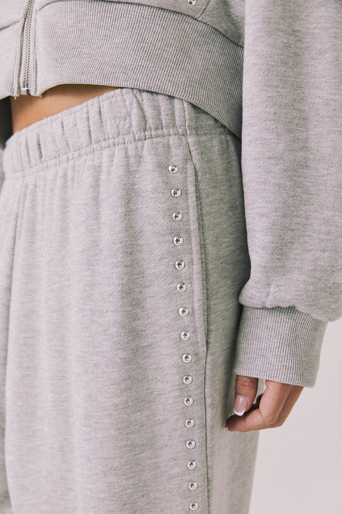 Side view of woman wearing Chaser’s Daze Heather Grey Joggers and sequin details on a white background