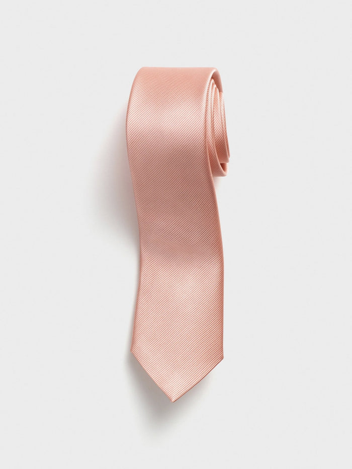 Peach silk necktie with a twill weave, coiled on a white background.