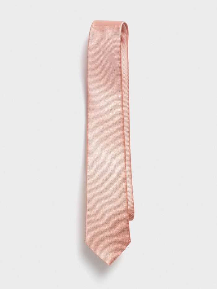 Peach silk necktie with a diagonal twill texture, hanging on a white background.