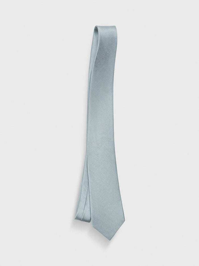 Deep sage grey-green silk necktie laid flat in a loose fold on a grey background.