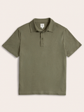 Olive green pique polo shirt laid flat, front view, on cream background