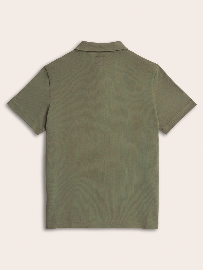 Olive green pique polo shirt laid flat, back view, on cream background