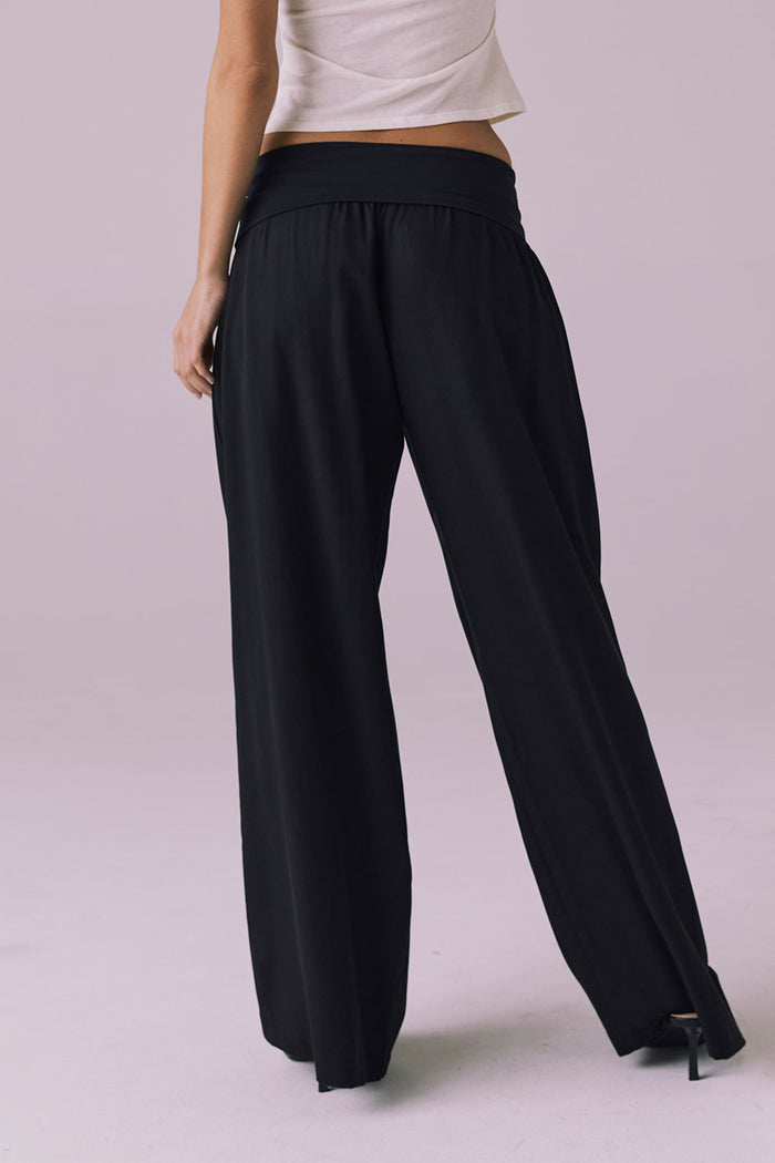 Back view of the Chaser Didion Licorice Black Trousers showing the smooth foldover waistband and long leg line