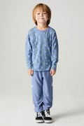 Full body front  view of a boy wearing the Chaser Dino Bolts Pants Boys Jogger on a neutral background with matching blue shirt