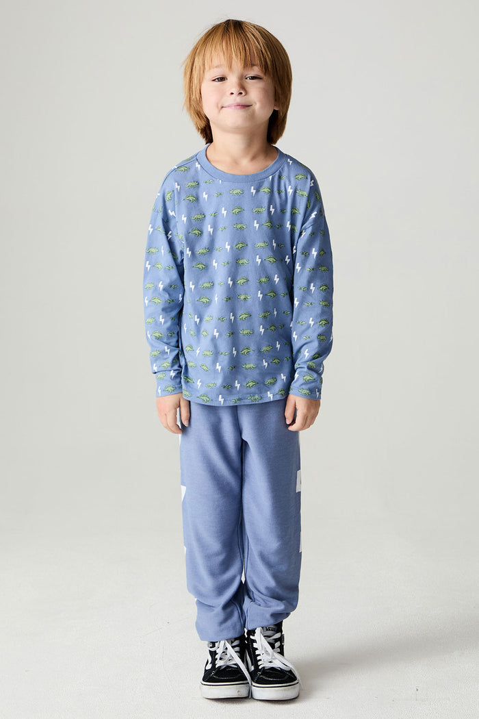 Full body front  view of a boy wearing the Chaser Dino Bolts Pants Boys Jogger on a neutral background with matching blue shirt