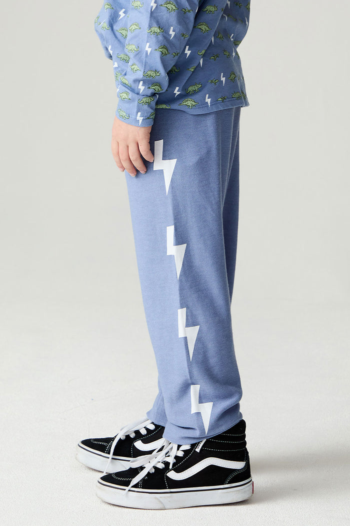 Side view of a boy wearing the Chaser Dino Bolts Pants Boys Jogger on a neutral background with shirt