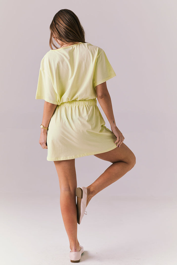 Full body back view of the Chaser Dixie Panna Cotta Mini Dress highlighting the airy cotton fabric and easy mini length