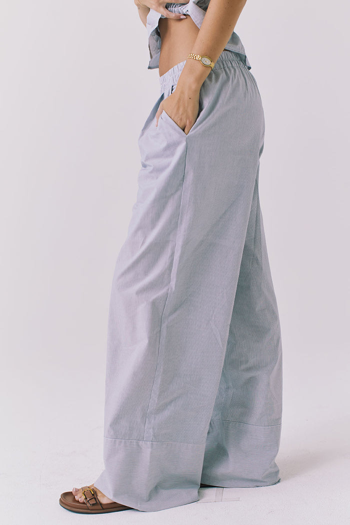 Side view of the Chaser Dorit Pinstripe Trousers highlighting the fluid silhouette pocket placement and lightweight fabric with subtle texture