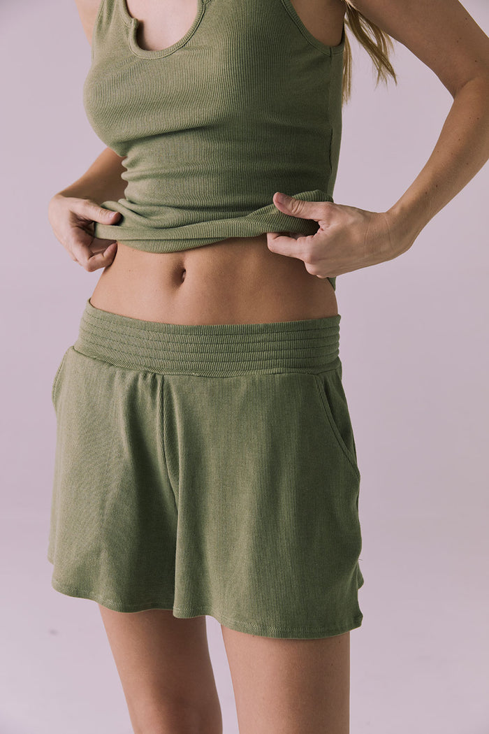 Close-up of the Chaser Durango Meadow Green Shorts highlighting the ribbed knit texture and wide elastic waistband