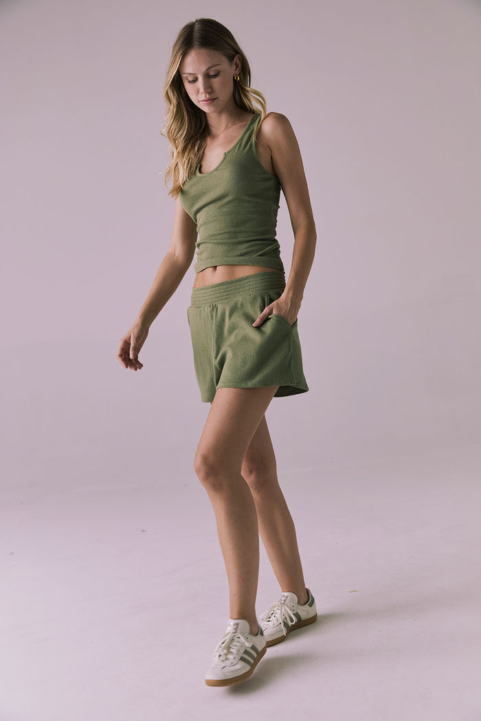 Full-body walking shot of the Chaser Durango Meadow Green Shorts paired with the matching Brandi Meadow Green Tank, styled with sneakers for a casual-cool look
