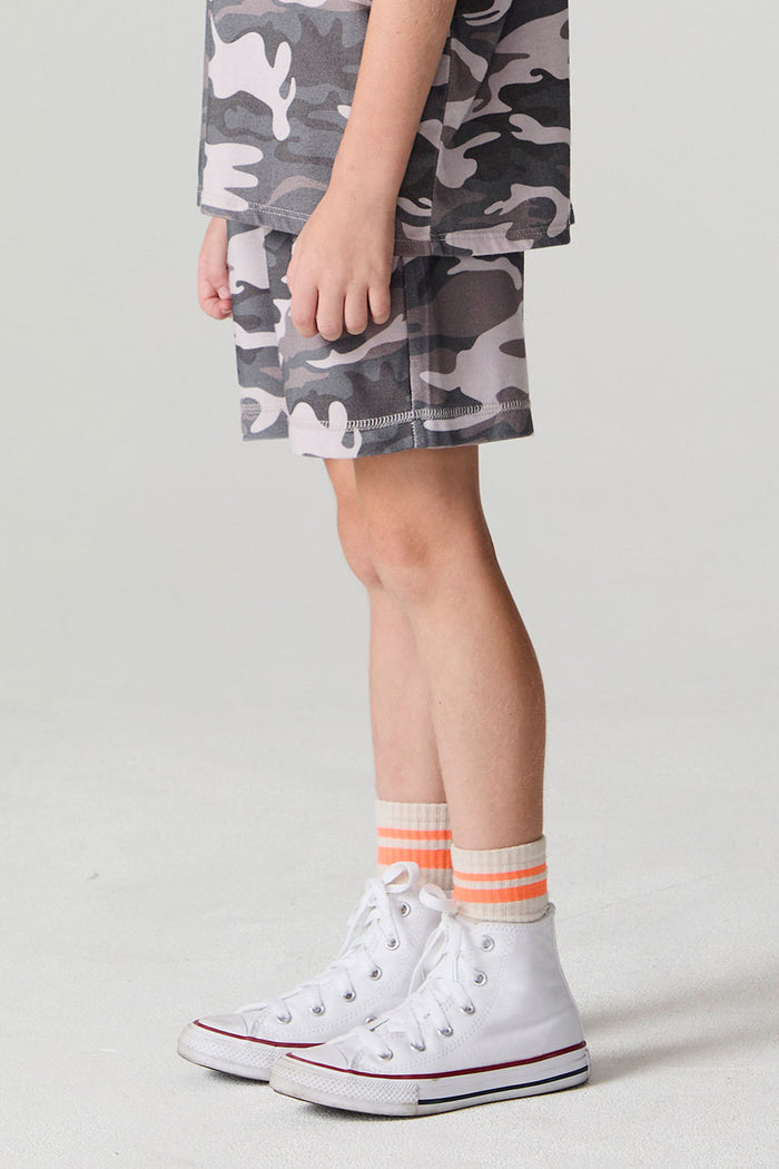 Side view of a boy wearing the Chaser Dusty Camo Shorts on a neutral background