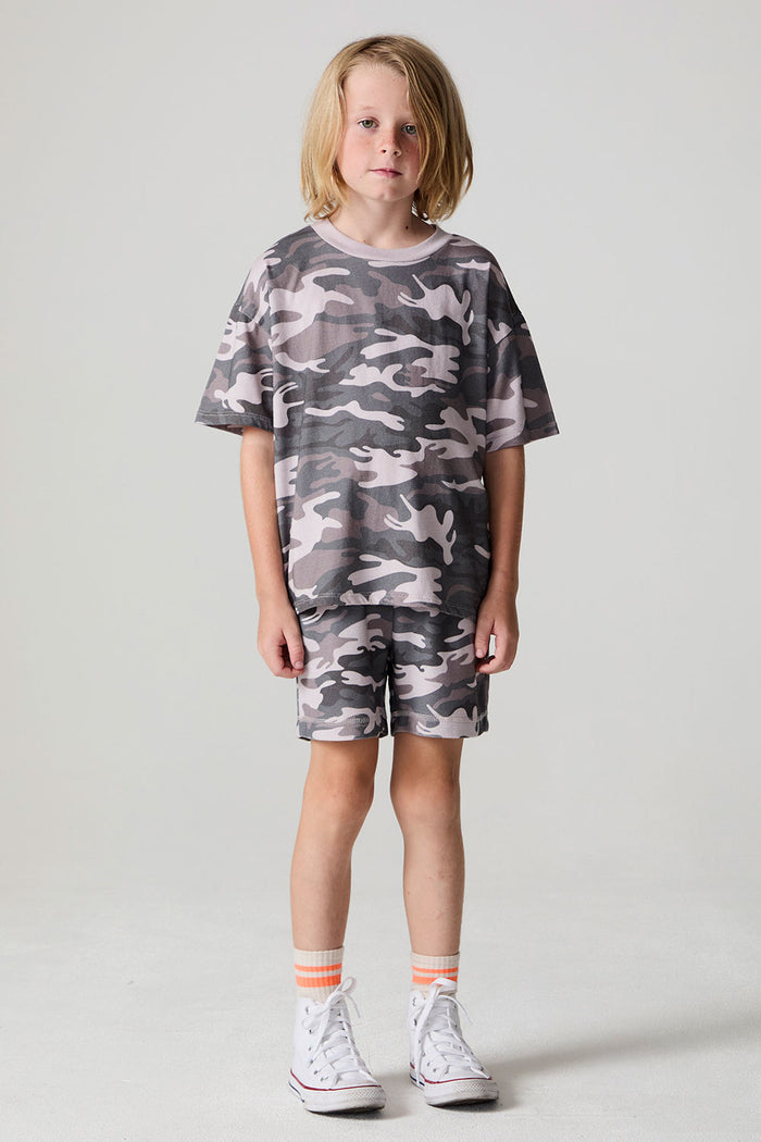 Full body front view of a boy wearing the Chaser Dusty Camo Tee  on a neutral background